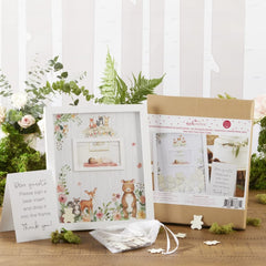 Kate Aspen woodland creatures illustration enhances rustic baby shower decor.