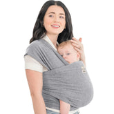 KeaBabies baby wrap carrier in classic gray worn on the front for secure bonding.