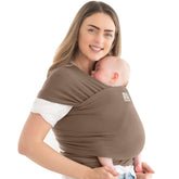 KeaBabies Original Baby Wrap Carrier in saddle brown worn for close, secure support on the go.