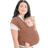 KeaBabies baby wrap carrier terracotta worn by a parent for on-the-go comfort