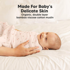 Baby swaddled in KeaBabies Lumi Muslin blanket, demonstrating snug, secure wrap.
