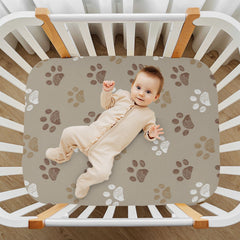 KICPOAY brown dog paws crib sheet on mattress demonstrating a secure fit.