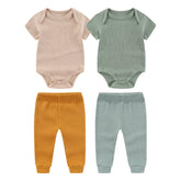 Kiddiezoom newborn layette bodysuit close-up highlighting soft cotton for tender baby skin.