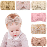 KIDOCHEESE baby bows with soft fabric close-up for gentle wear.