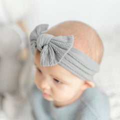 Kidocheese brown headband with bow providing secure, comfortable fit.