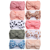 KIDOCHEESE oversized bow headband for newborns with soft elasticity, gentle on delicate heads.