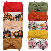 KIDOCHEESE oversized bow headband with soft elastic for newborn comfort.