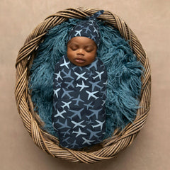 KiuLoam camouflage blue jets baby-model demonstrates easy-to-wear cocoon care.