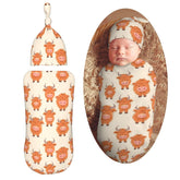 KiuLoam cow swaddle blanket close-up showing soft fabric for newborn comfort.