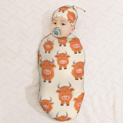 KiuLoam newborn swaddle cocoon demonstrating secure wrap and gentle warmth.