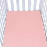 Knlpruhk silk fitted crib sheet on mattress showing surface smoothness for baby comfort.