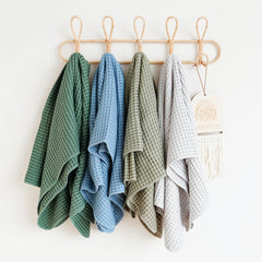 Konssy waffle blanket shown as multi-use wrap for baby.