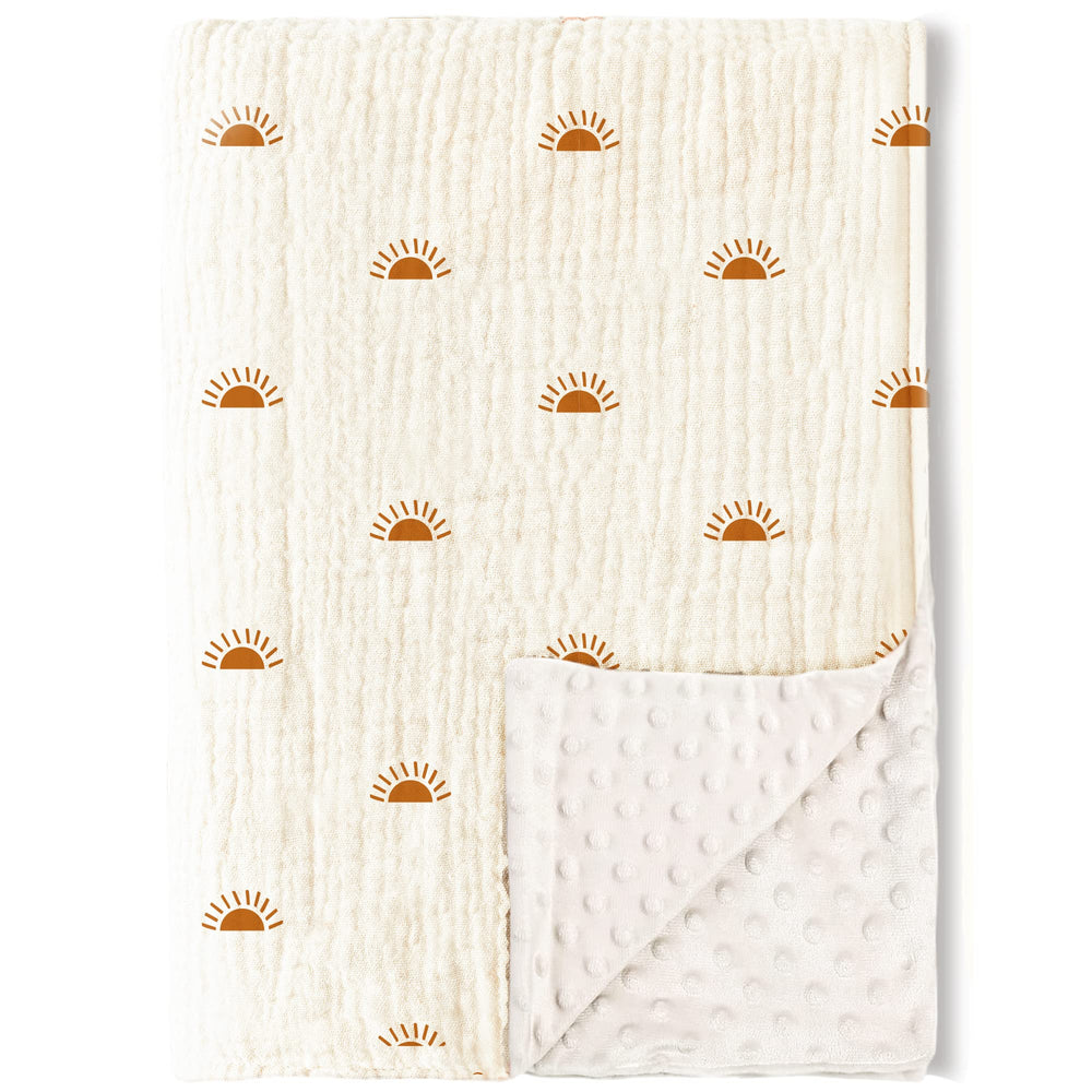 Konssy baby blanket with muslin front and dotted fleece back for gentle warmth.