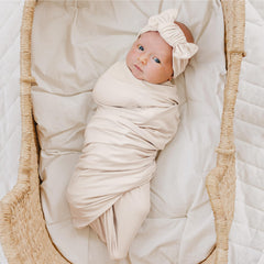 Konssy matching headband and bows highlight newborn styling for photos.