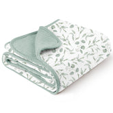 Konssy muslin blanket with green leaves pattern for soft, breathable baby warmth.