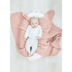 Konssy Waffle Baby Blanket pink on crib for warm, safe nap time.