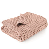 Konssy waffle baby blanket in blush pink shows soft, cozy texture for nap time.