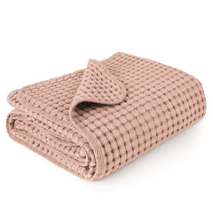 Konssy waffle baby blanket in blush pink shows soft, cozy texture for nap time.
