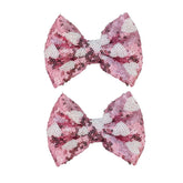 Koolgil pink heart glitter bow hair clip adds sparkle and holds hair in place.