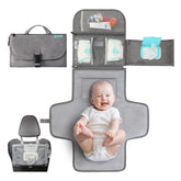 Kopi Baby portable changing pad in grey, open, ready for quick diaper changes on the go.