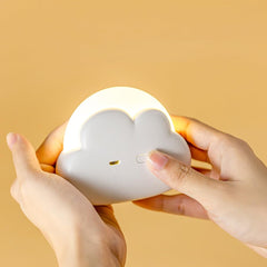Kvensin cloud night light with wrist strap for portable bedside use.