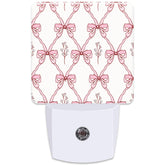 KXWQTRDD pink ribbon night light, front view with warm glow for kids' rooms