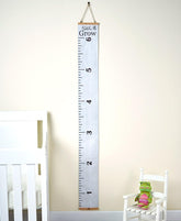 The Lakeside Collection sentiment ruler growth chart mounted in a cozy nursery for milestone tracking