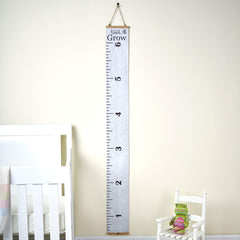 Watch Me Grow growth chart on the wall in a bright bedroom setting