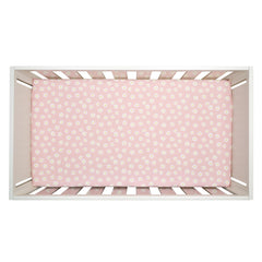 Lambs & Ivy Daisy Dreams elastic-fit sheet stays snug on crib mattresses.