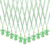 Lassos Boutique green pacifier necklace on table scatter for baby shower decor