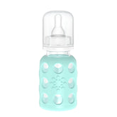 Lifefactory glass baby bottle with mint sleeve for secure grip.