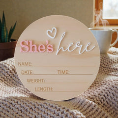 LINHTEVIE birth sign She’s Here pink heart, ideal for newborn photo sessions.