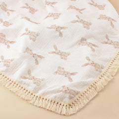 Little Jump boho fringe trim on muslin blanket for chic nursery decor.