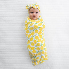 Little Sleepies lemons swaddle used as stroller shade on sunny days