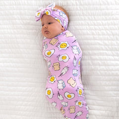 Little Sleepies Lunaluxe newborn wearing swaddle; snug wrap for cozy photos