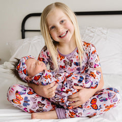 Little Sleepies Butterfly Kisses swaddle demonstrates stroller shade and play mat versatility.