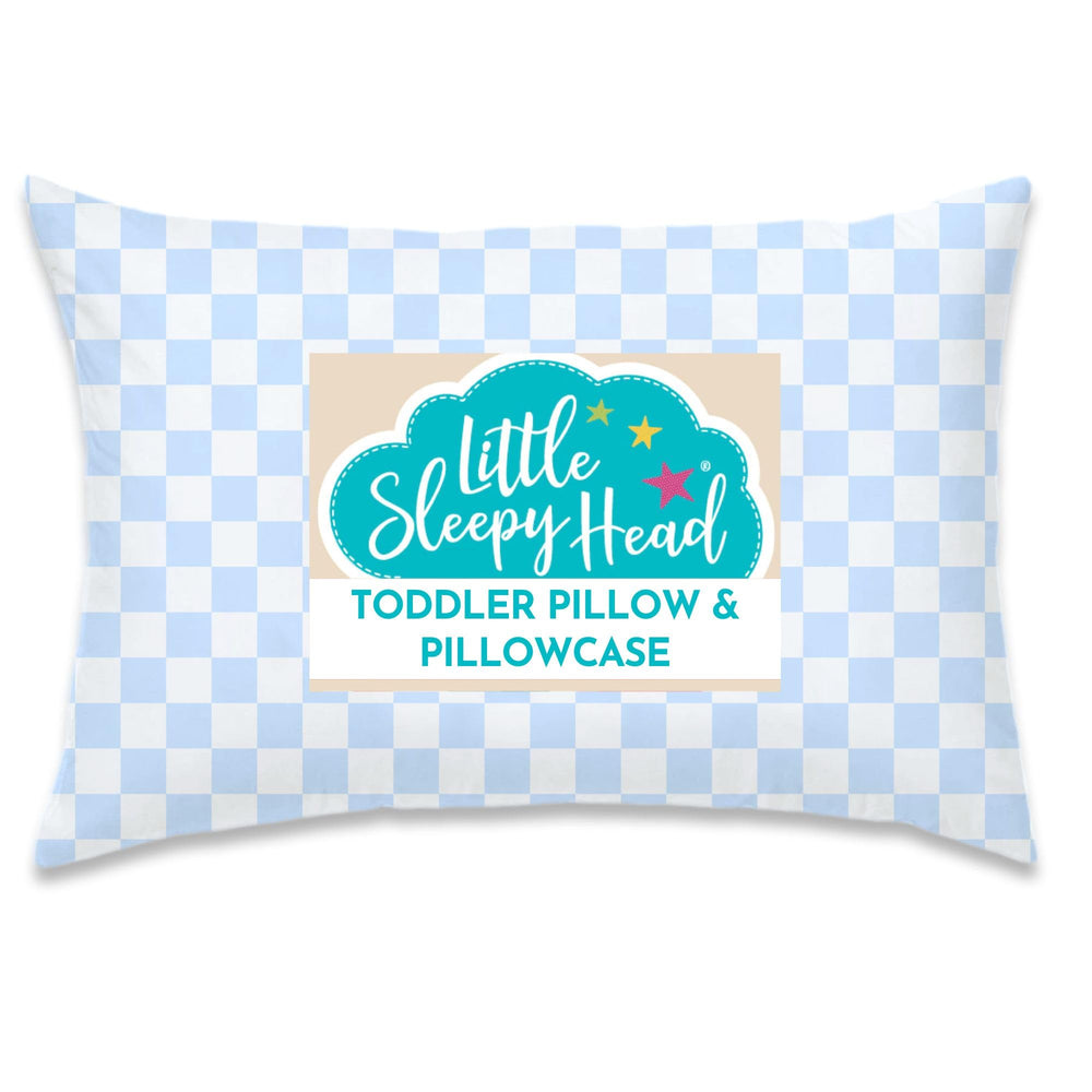 Little Sleepy Head toddler pillow in checkers baby blue resting on a bed for sweet dreams