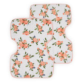 Little Unicorn burp cloth on shoulder with soft muslin for gentle coverage.
