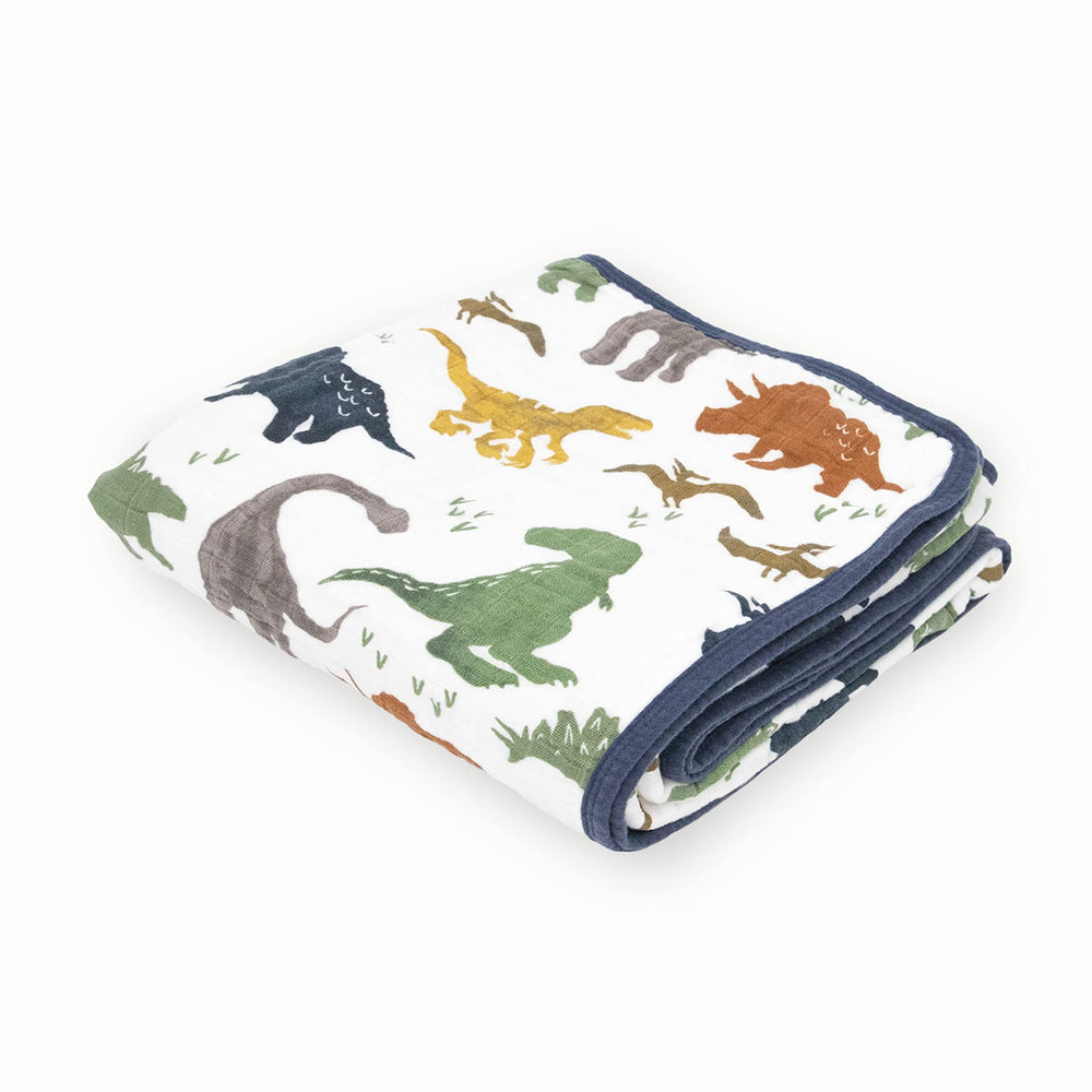 Little Unicorn Dino Friends quilt top view shows soft, breathable cotton for cozy cuddles.