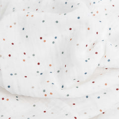 Little Unicorn dots swaddle wrapped baby demonstrating secure cozy swaddling