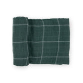 Little Unicorn evergreen plaid swaddle blanket showing breathable cotton softness for baby comfort.