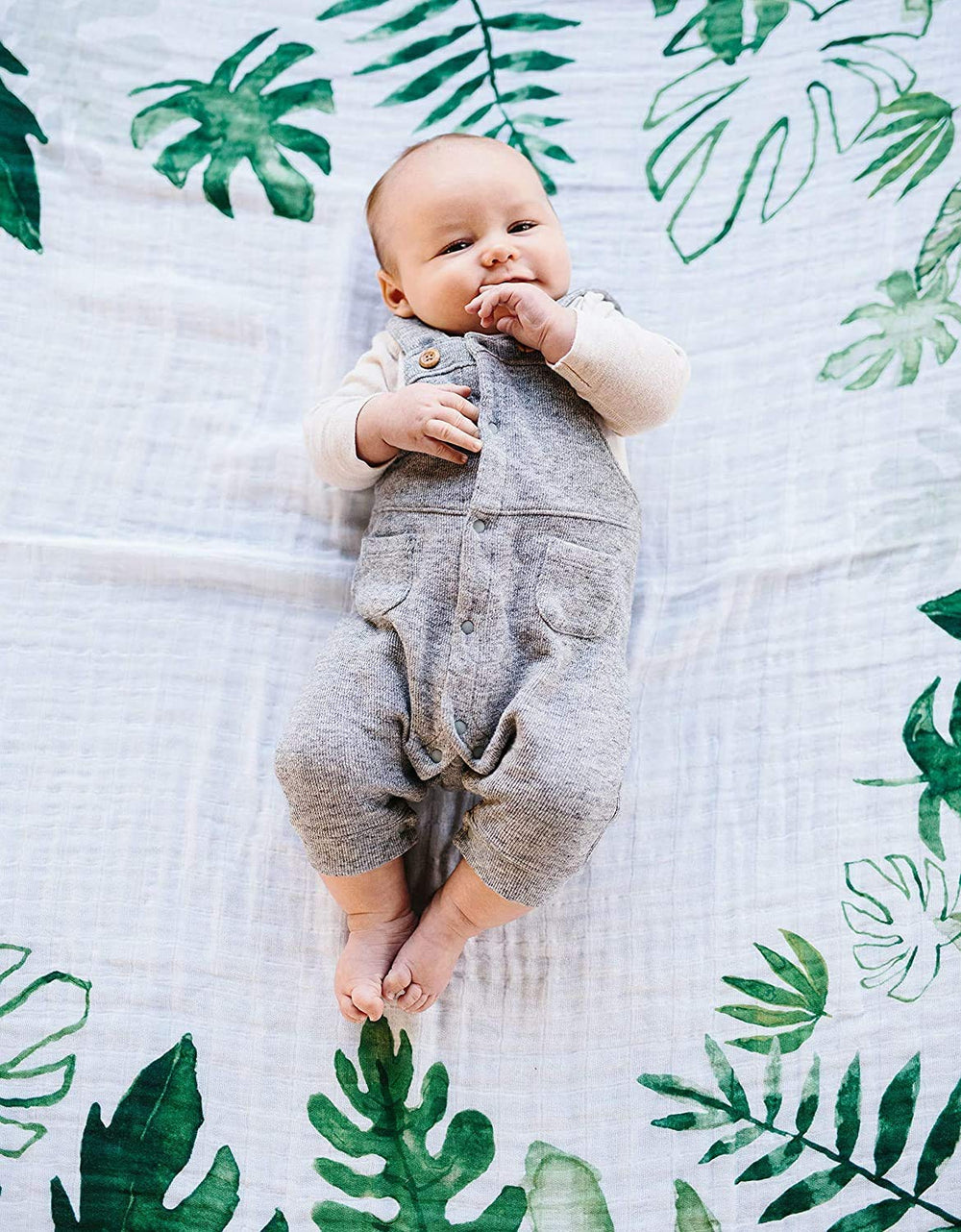 Little Unicorn milestone blanket tropical leaf backdrop for baby photos