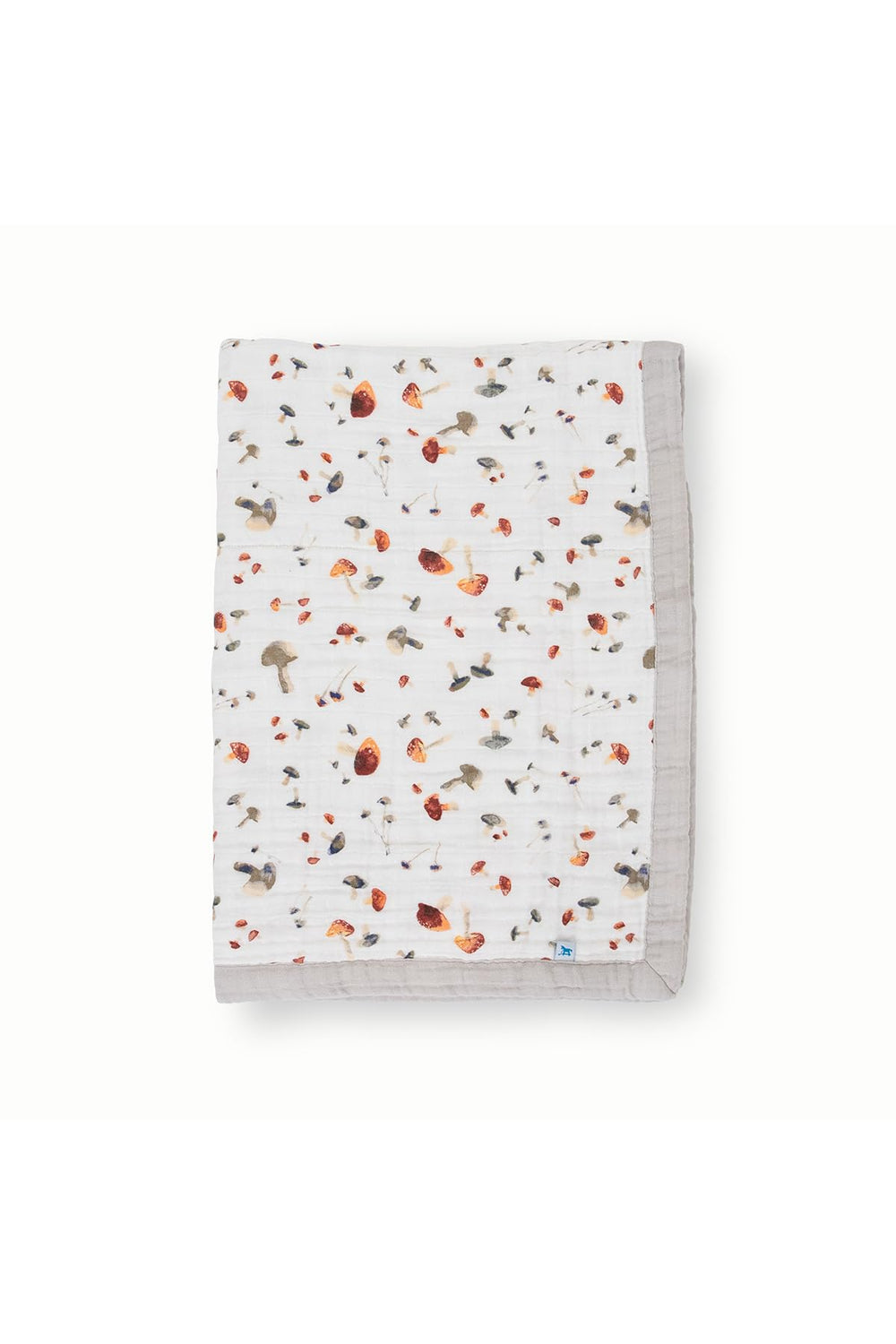 Little Unicorn newborn receiving quilt mushrooms close-up, breathable muslin for gentle warmth