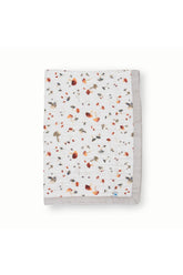 Little Unicorn newborn receiving quilt mushrooms close-up, breathable muslin for gentle warmth