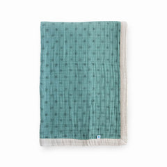 Little Unicorn newborn quilt: soft-weave fabric close-up for gentle skin contact.