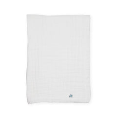 Little Unicorn organic newborn quilt folded for easy storage.