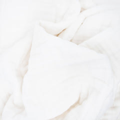 Little Unicorn organic quilt in nursery decor offering soft ambience.