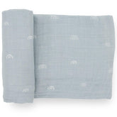 Little Unicorn swaddle flatlay with breathable cotton muslin and blue rainbow design for comfort