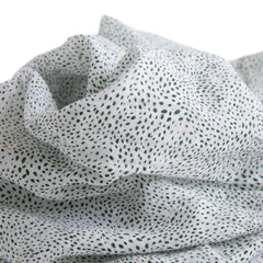 Little Unicorn swaddle close-up shows soft muslin fabric for gentle hugs.