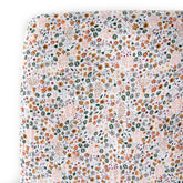 Little Unicorn Premium Crib Sheet with pressed petals on mattress for breathable softness.